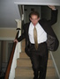 Gabi descends, clad in suit